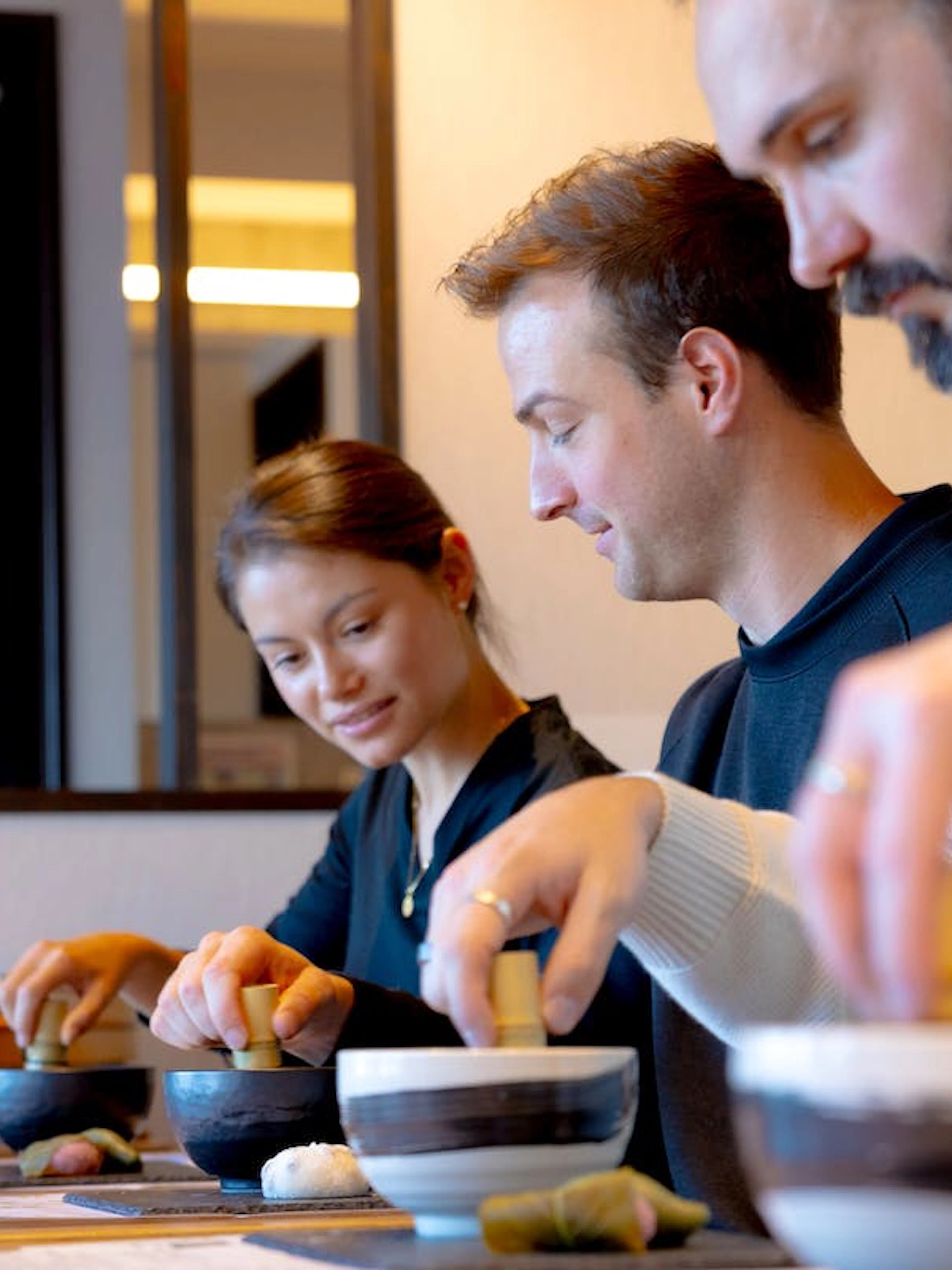 Participants preparing matcha in an Osaka cooking class.