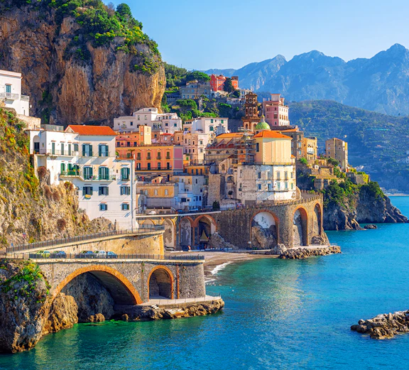 Cornucopia Majesty Yacht cruising near Amalfi Coast cliffs, Halloween Goes Hollywood event.