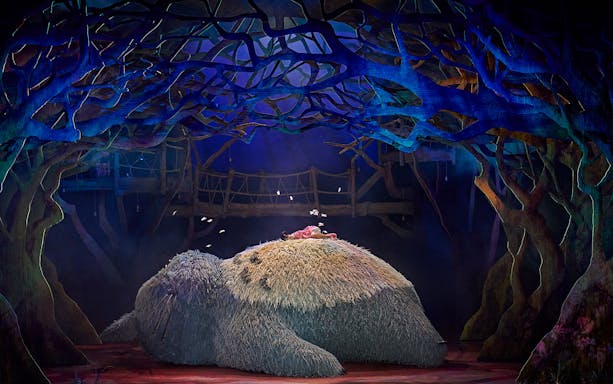 Stage scene from My Neighbour Totoro show in West End with Totoro and child.