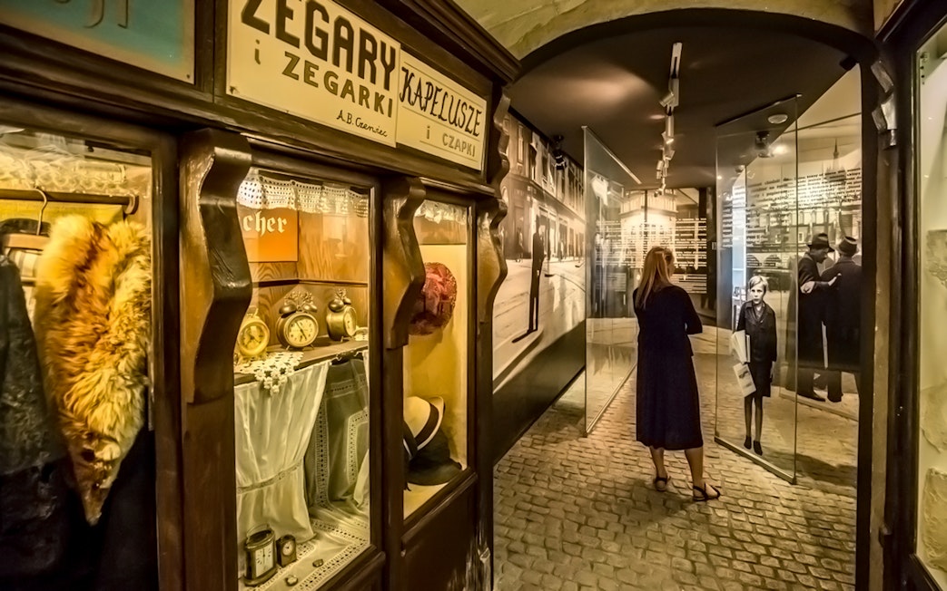 Visitor exploring exhibits inside Schindler's Factory Museum, Krakow.