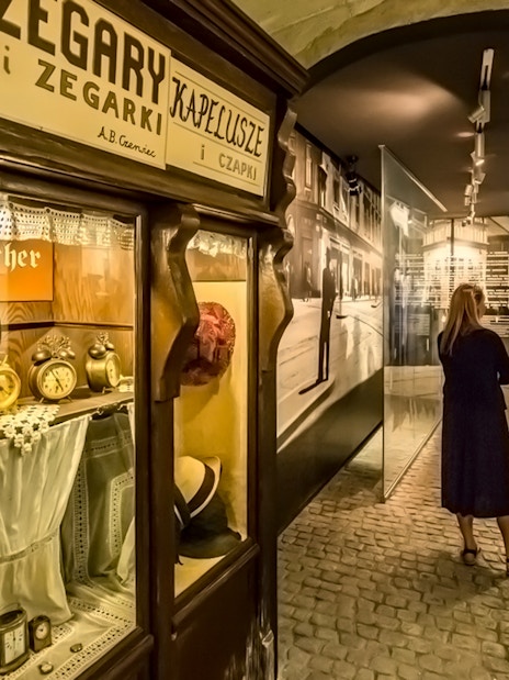 Visitor exploring exhibits inside Schindler's Factory Museum, Krakow.