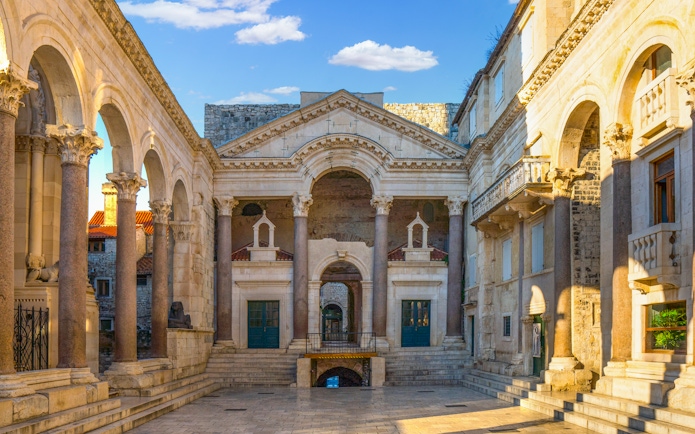 Diocletian's Palace peristyle in Split, Croatia, featuring ancient Roman columns and arches.