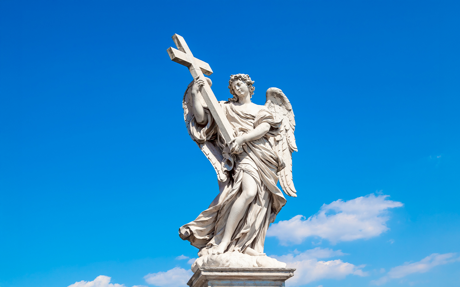 Angel statue holding a cross on Ponte Sant’Angelo bridge, Rome, Italy.