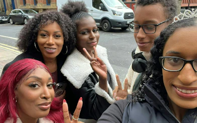 Group of friends posing on a street during Manchester Ghost Hunt city exploration game.