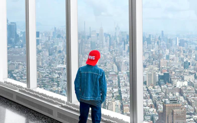 Tourist viewing New York City skyline from One World Observatory.