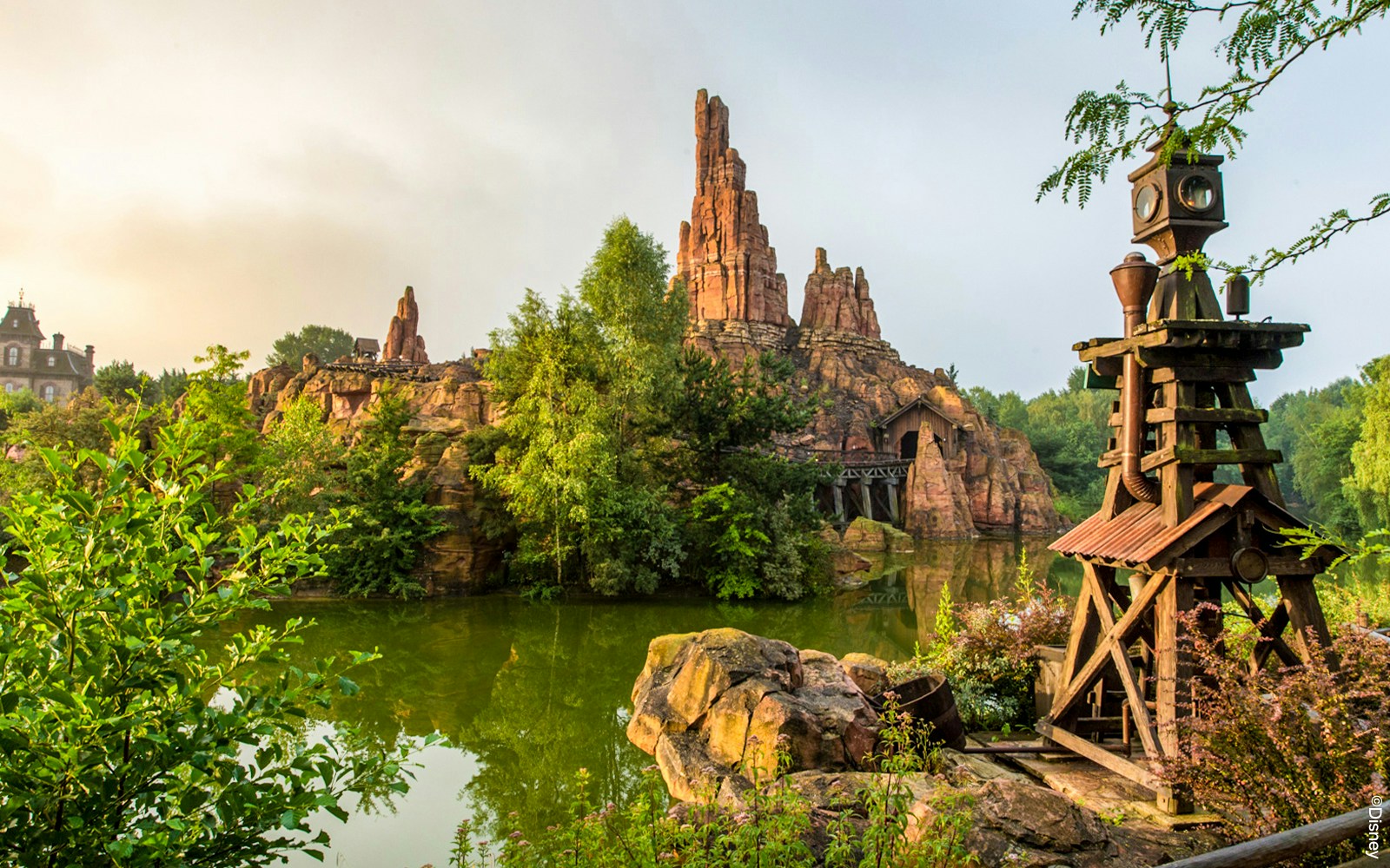 Frontierland Big Thunder Mountain roller coaster at Disneyland Park Paris with rocky landscape.