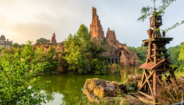 Frontierland Big Thunder Mountain roller coaster at Disneyland Park Paris with rocky landscape.