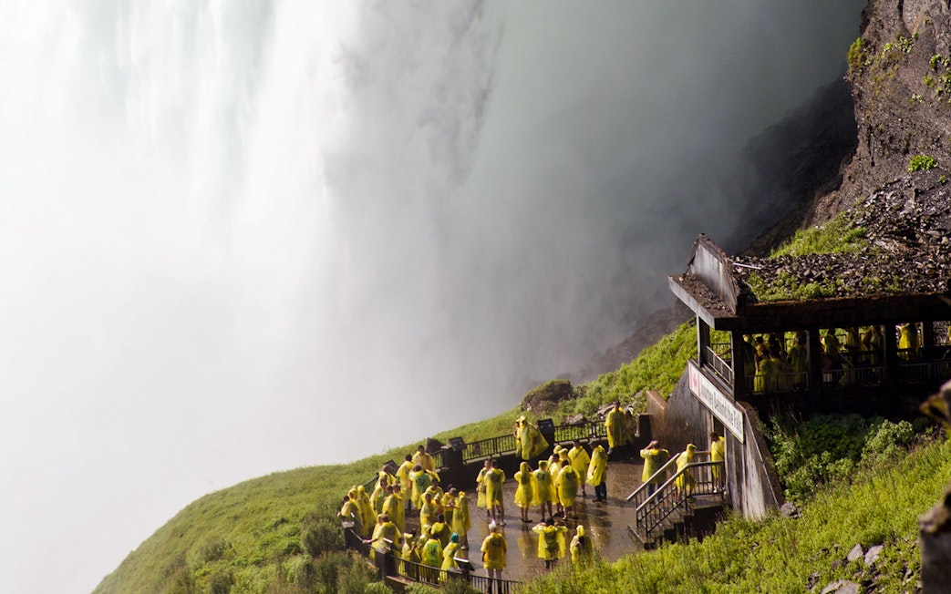 Tourists in yellow ponchos at Journey Behind the Falls, Niagara Falls.
