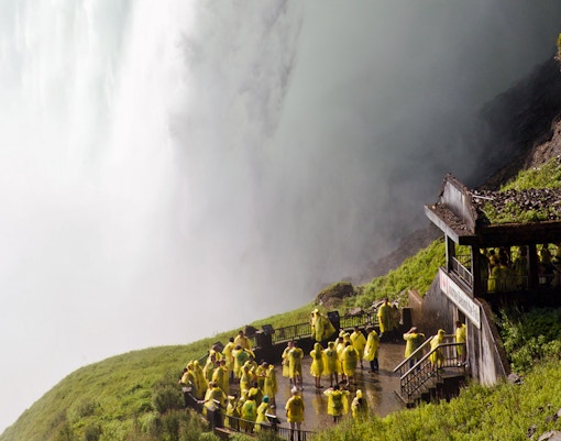 Tourists in yellow ponchos at Journey Behind the Falls, Niagara Falls.