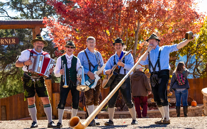 Performers in traditional Bavarian attire at Glenwood Caverns Adventure Park.