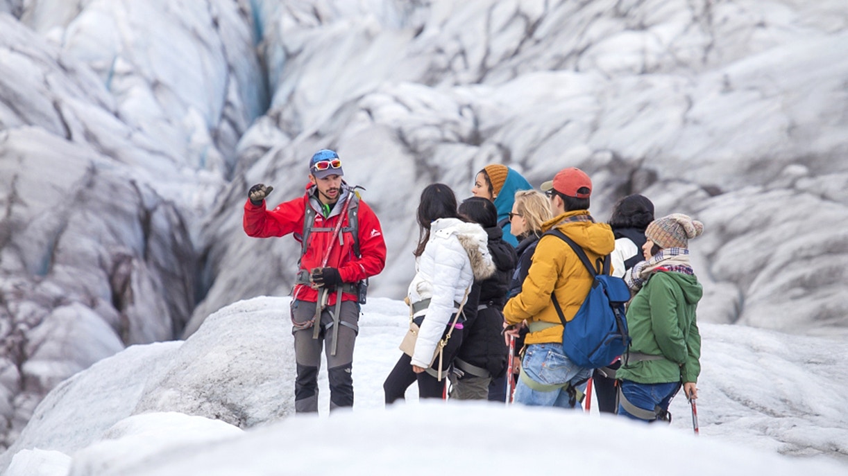 Tour guide explaining glacier features to group during Blue Ice Experience at Skaftafell.