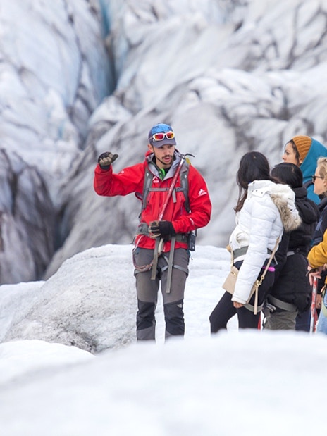 Tour guide explaining glacier features to group during Blue Ice Experience at Skaftafell.