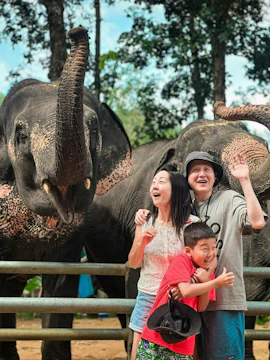 Family with two Asian elephants at Phuket Elephant Care, Sakhu.