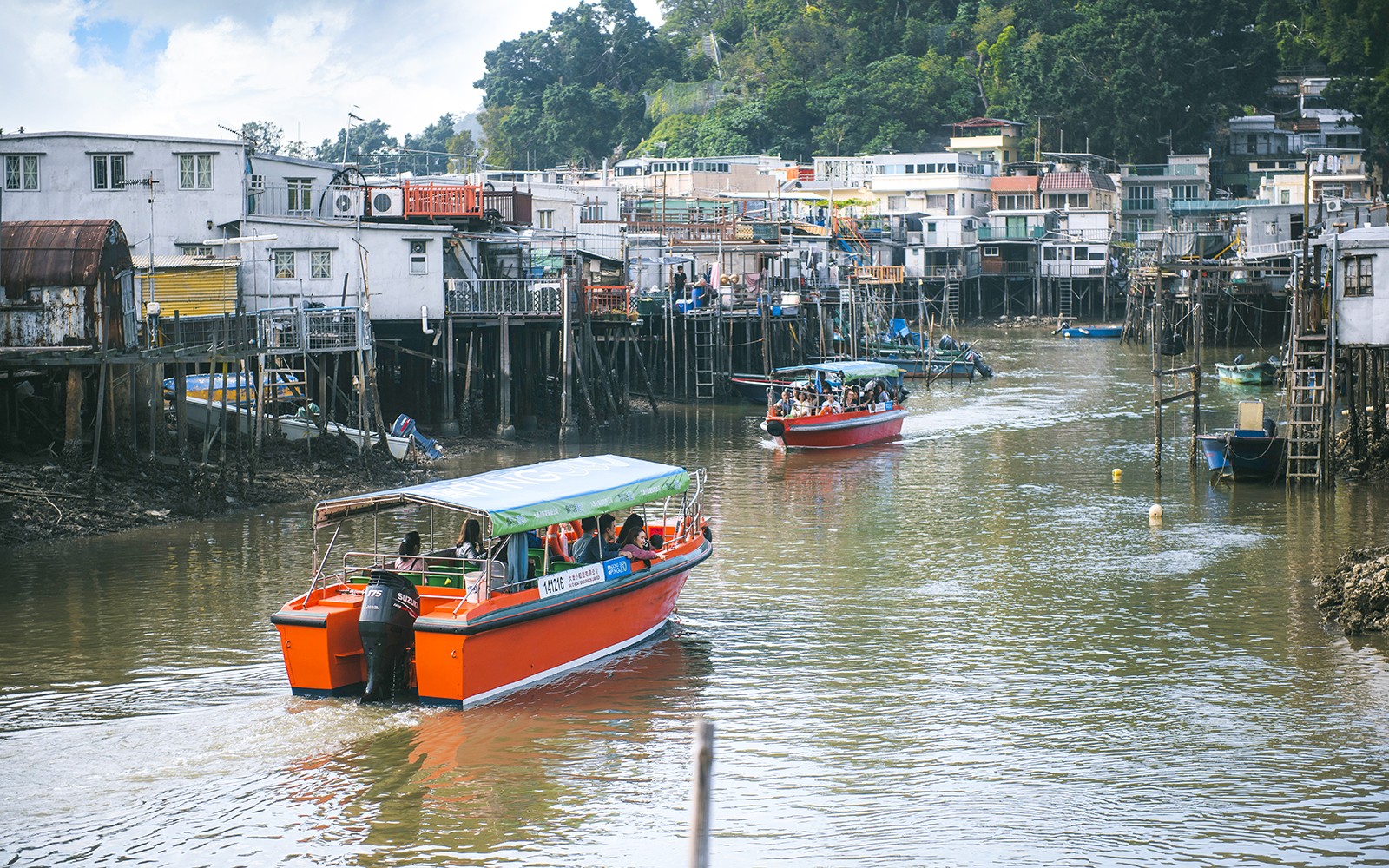 Boats navigating the waterways of Tai O Fishing Village on Lantau Island.