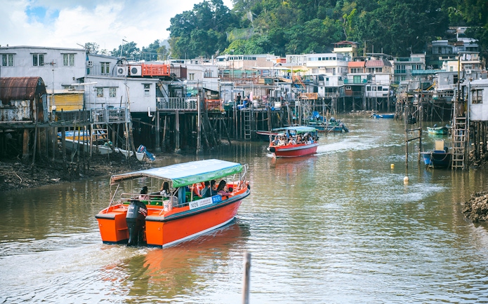Boats navigating the waterways of Tai O Fishing Village on Lantau Island.
