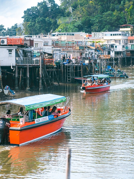 Boats navigating the waterways of Tai O Fishing Village on Lantau Island.