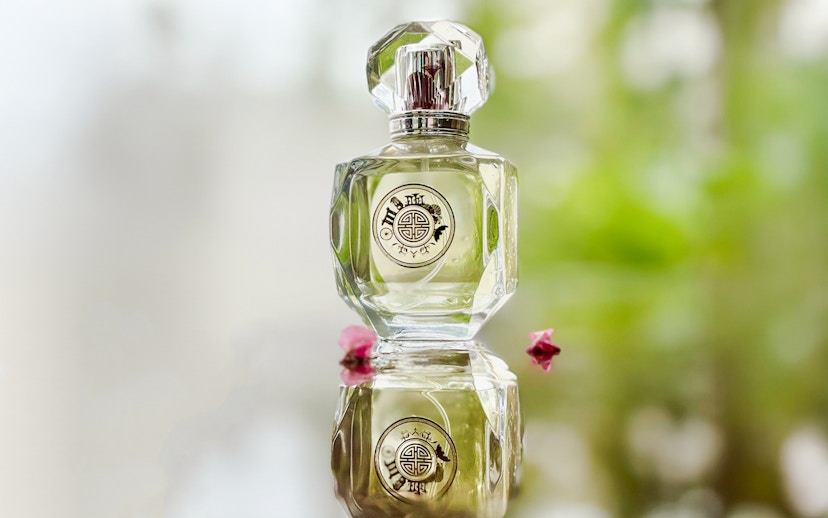 Premium perfume bottle Scentopia Sentosa Singapore with floral reflection.