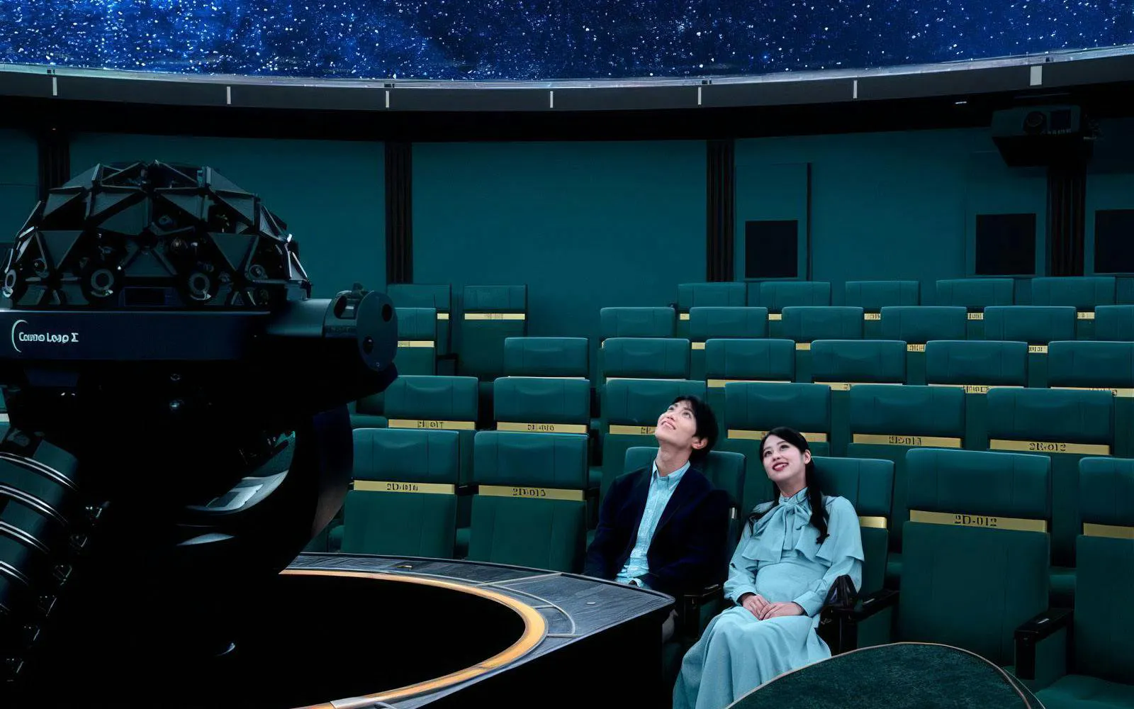 Young couple seated at Konica Minolta Planetaria TOKYO Ginza, gazing at starry dome.
