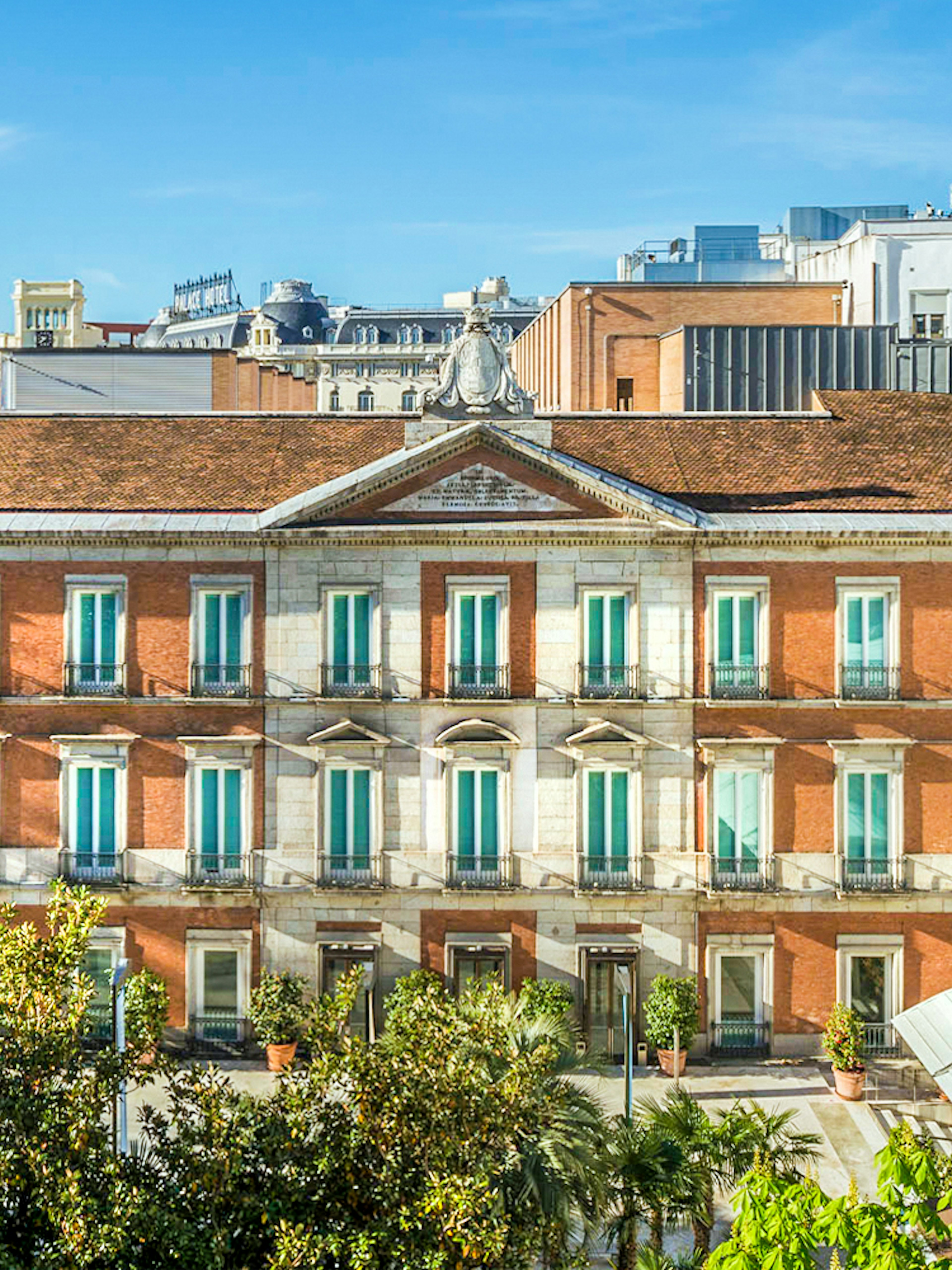 Exterior view of the Thyssen Museum in Madrid with red brick facade.