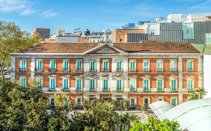 Exterior view of the Thyssen Museum in Madrid with red brick facade.