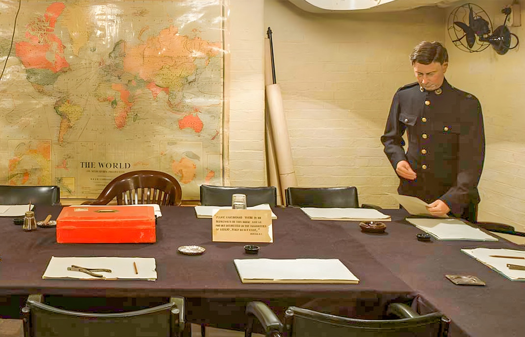 Churchill War Rooms with map and officer during tour with audioguide.