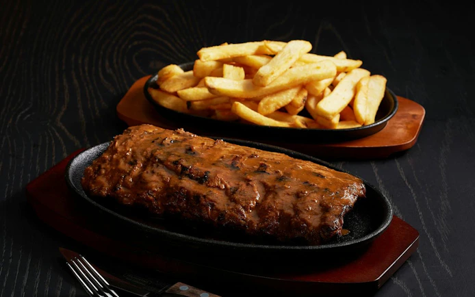 Ribs with fries served on a sizzling platter during Tomb of the Pharaoh Sunset tour.