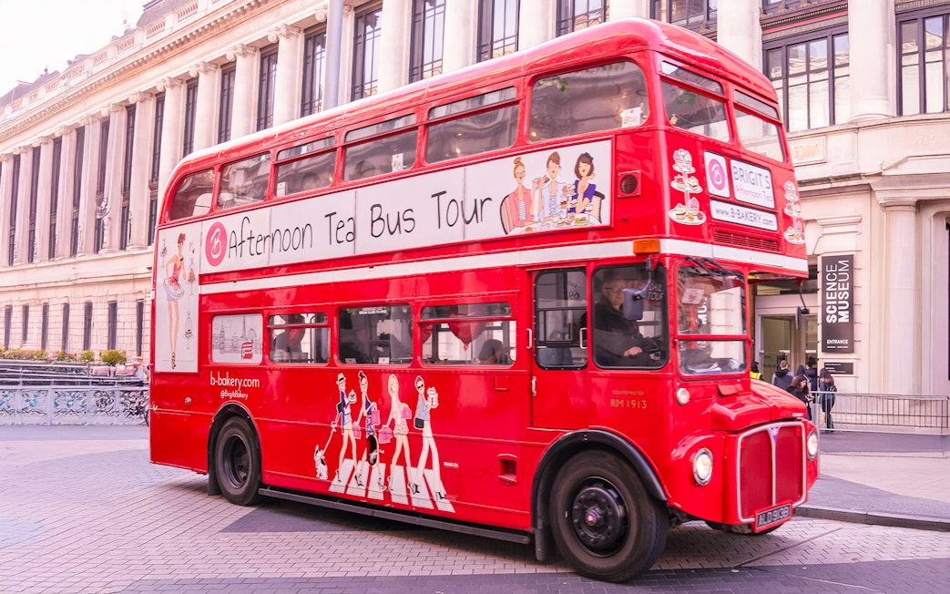 Red double-decker bus for Brigit's Bakery Afternoon Tea Tour in front of the Science Museum, London.