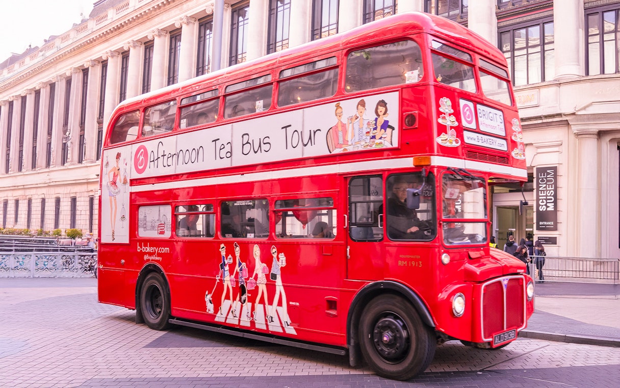 Red double-decker bus for Brigit's Bakery Afternoon Tea Tour in front of the Science Museum, London.
