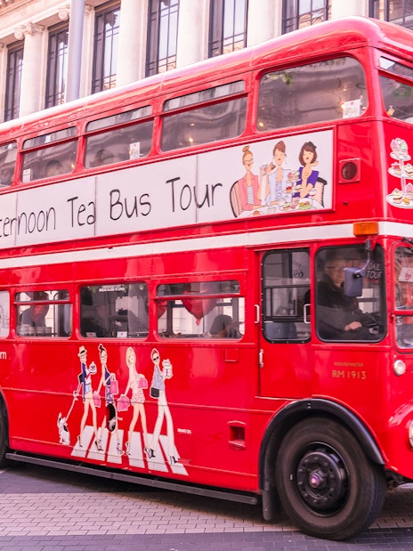 Red double-decker bus for Brigit's Bakery Afternoon Tea Tour in front of the Science Museum, London.