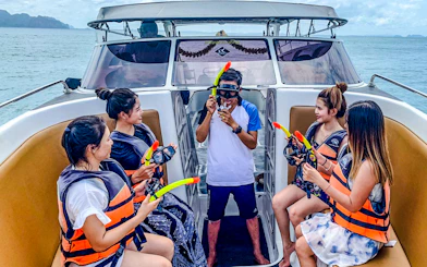Tourists on boat receiving snorkeling instructions during Krabi 4 island trip.