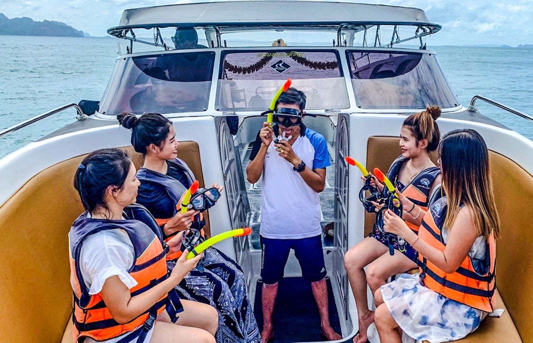 Tourists on boat receiving snorkeling instructions during Krabi 4 island trip.