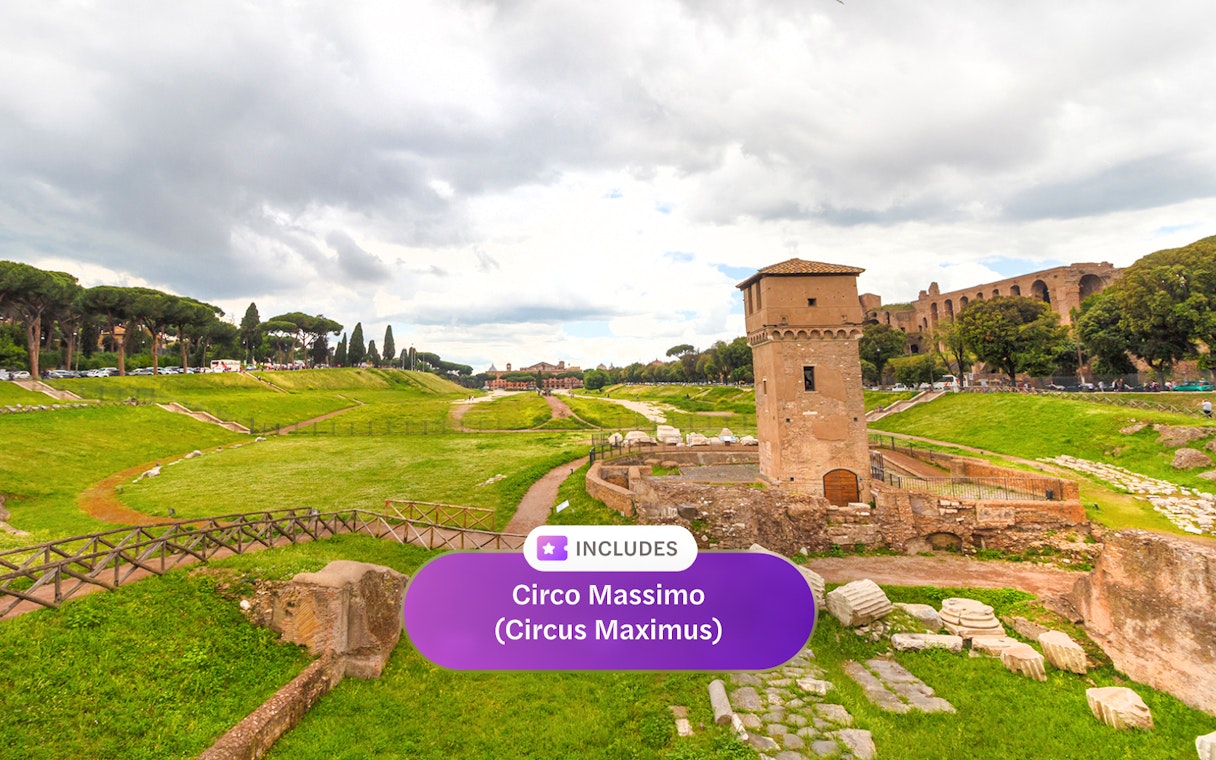Ancient ruins and tower at Circo Massimo, Rome, with green landscape and cloudy sky.