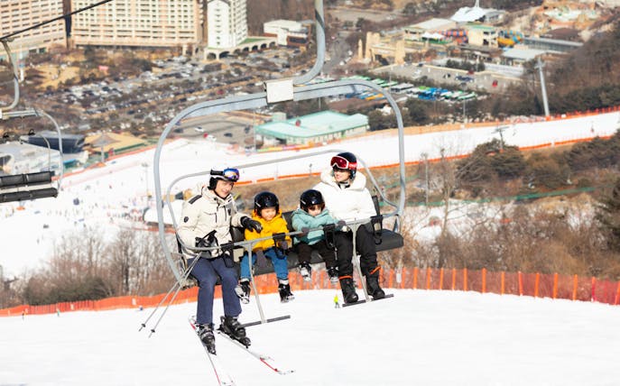 Family on ski lift at Vivaldi Park ski resort.