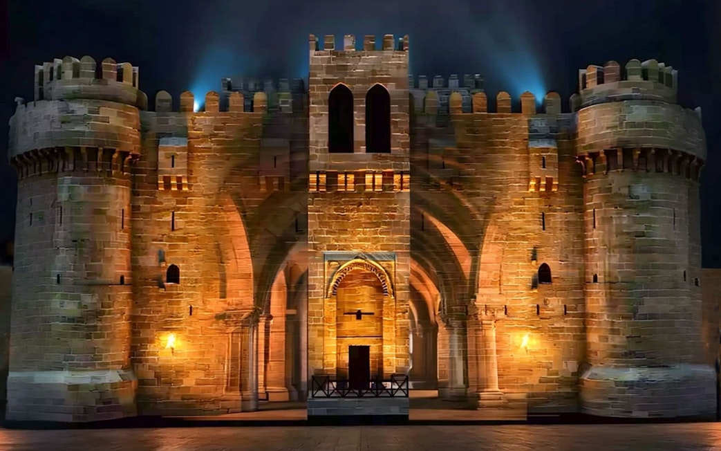 Qaitbay Citadel illuminated at night in Alexandria, Egypt.