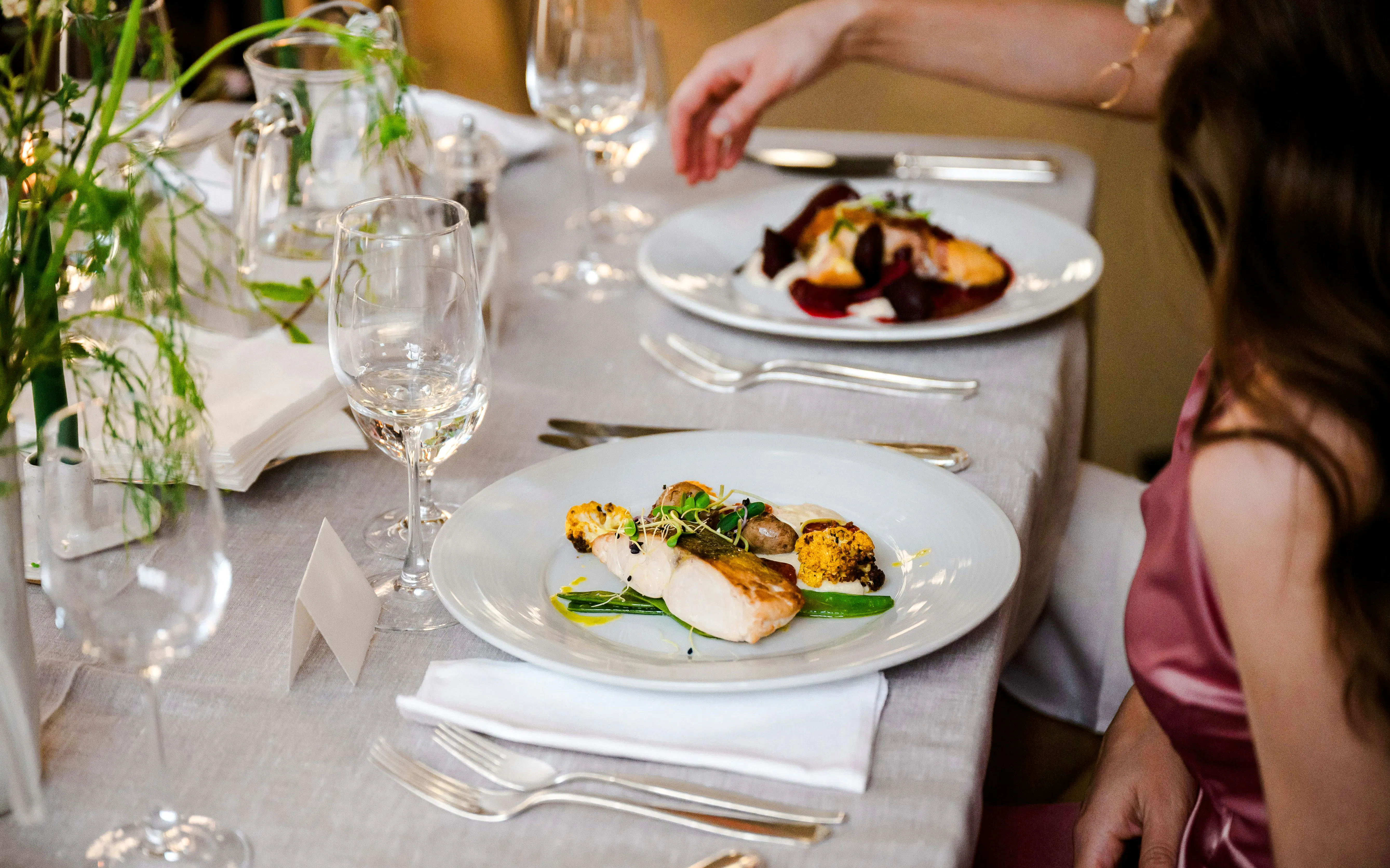 Mediterranean wedding menu with grilled chicken and vegetables on an elegant table setting.