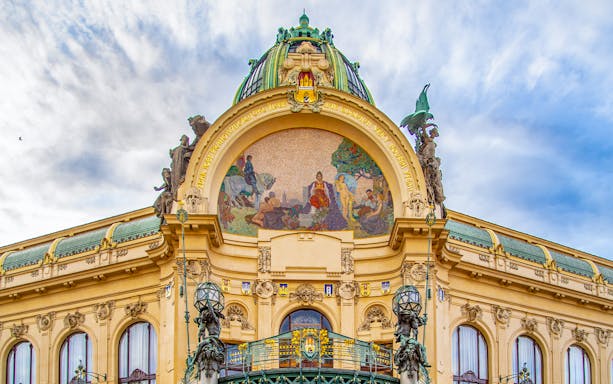 Municipal House facade with mosaic in Prague's Old Town.