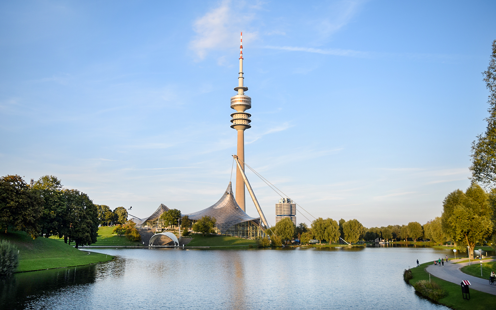 Olympic Tower in Munich with surrounding park and lake.