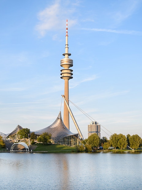 Olympic Tower in Munich with surrounding park and lake.