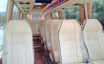 Minibus interior with comfortable seating for Meteora tour transport.