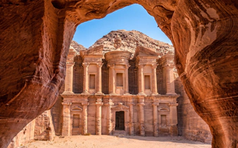 Petra's Al-Deir Monastery framed by rock formations, Jordan.