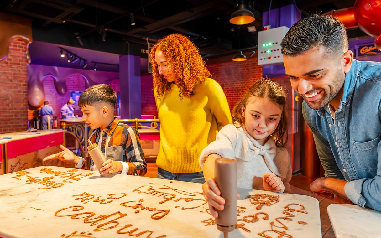 Guests creating chocolate art at Cadbury World Bourneville Experience.