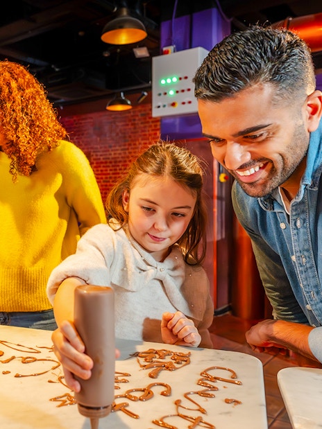 Guests creating chocolate art at Cadbury World Bourneville Experience.