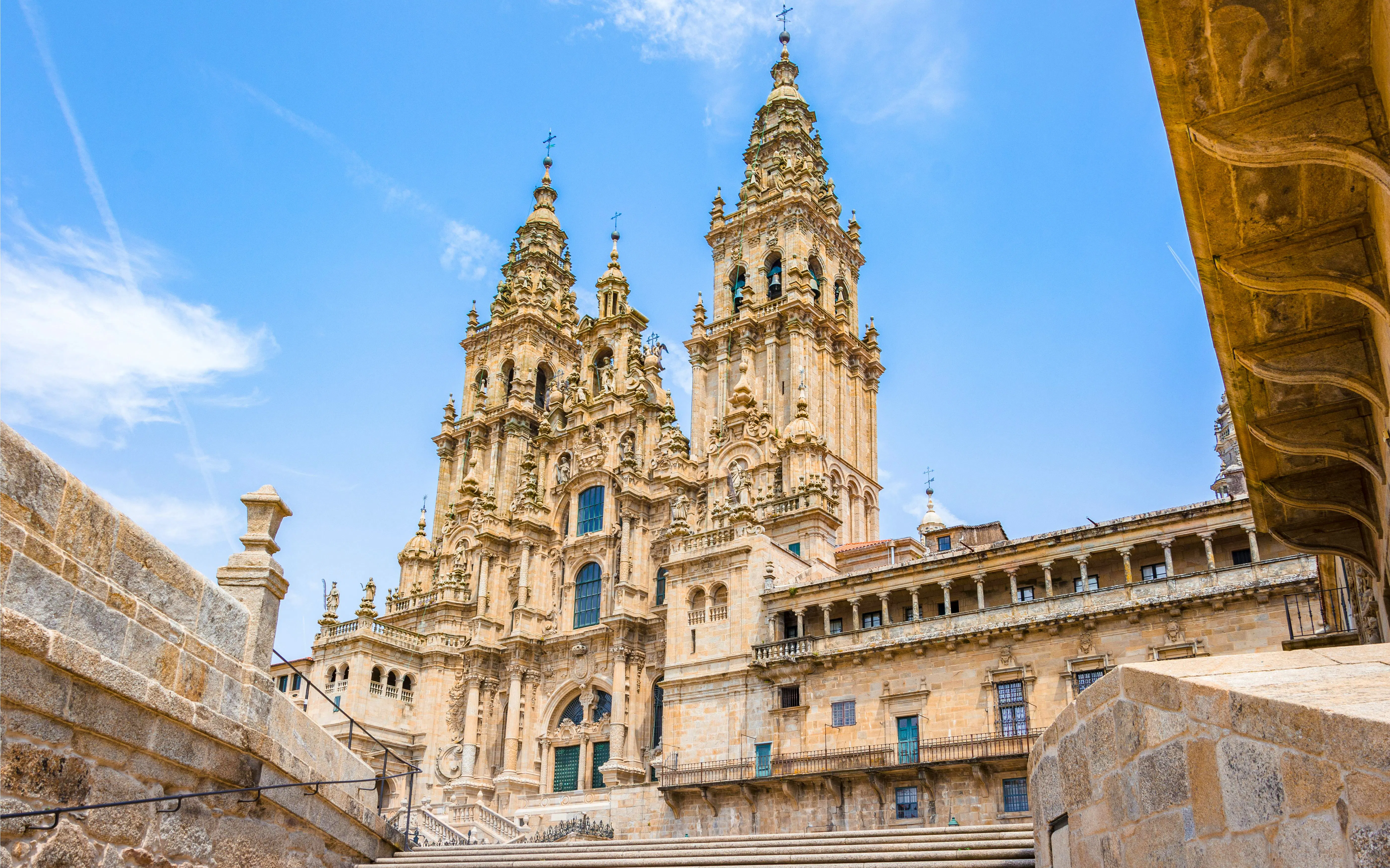 Cathedral of Santiago de Compostela with twin spires under a clear blue sky, Spain.