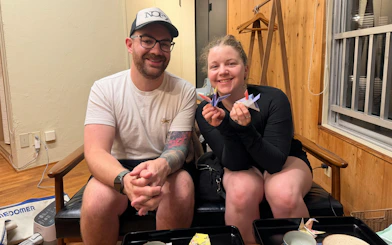 Couple enjoying origami before massage and acupuncture session in Hiroshima.