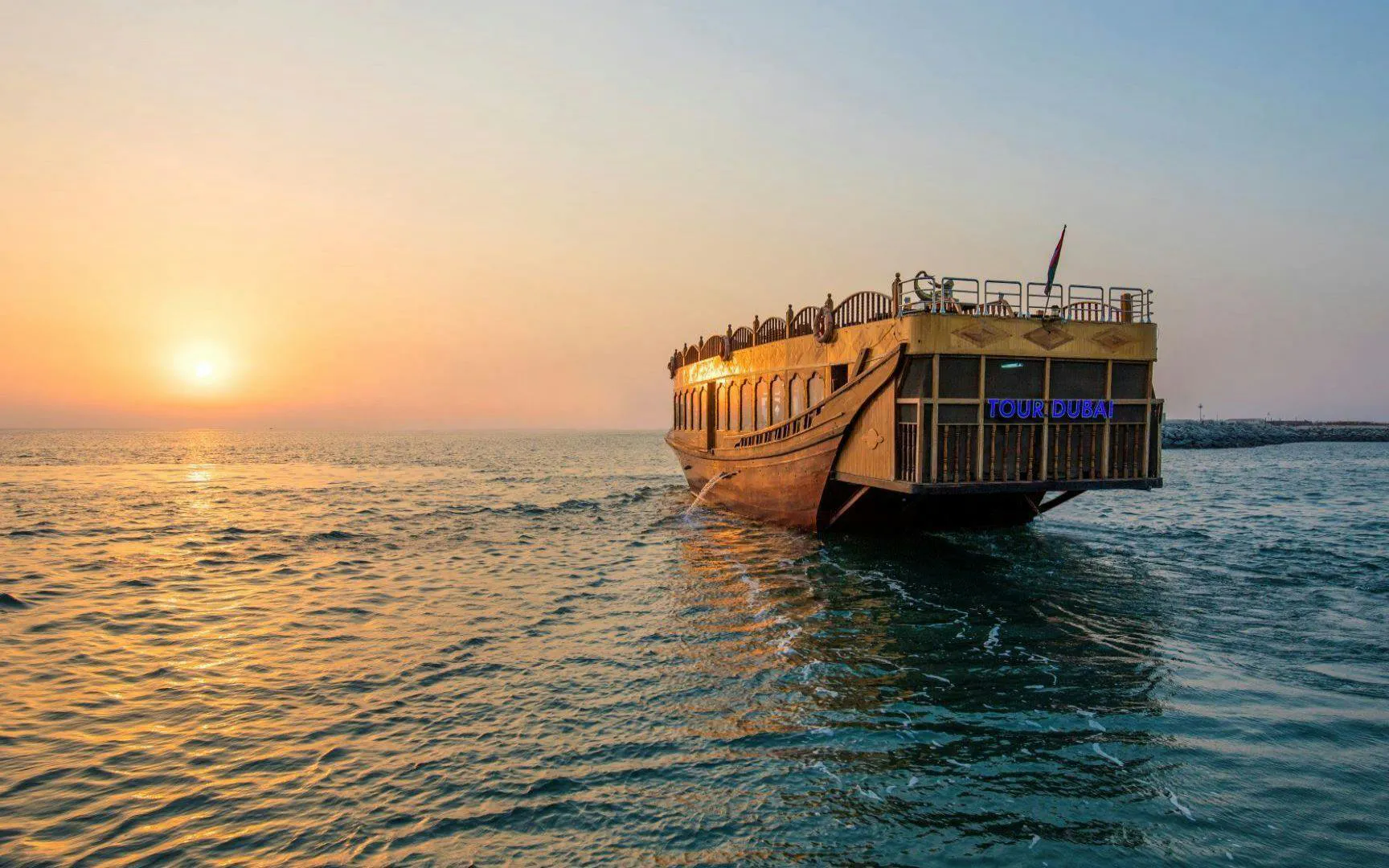 Dhow cruise at sunset on Dubai Marina waters.