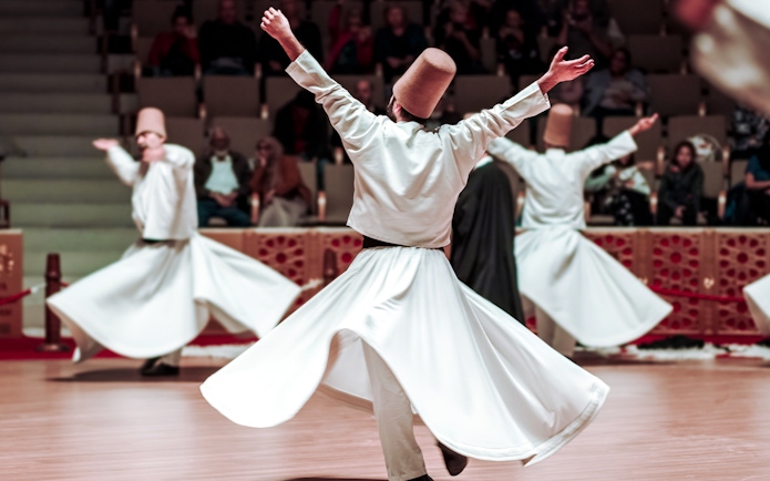 Whirling Dervishes performing in a cultural ceremony.