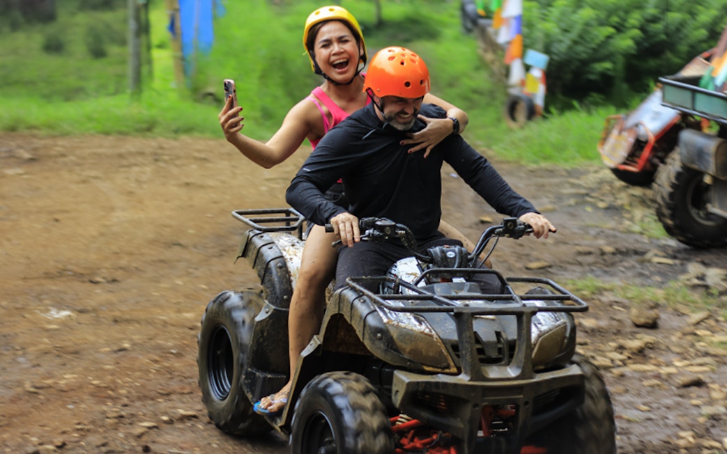 ATV ride at Dago Dreampark, Bandung, with two people enjoying the adventure.