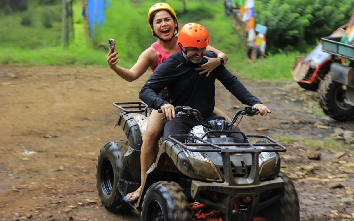 ATV ride at Dago Dreampark, Bandung, with two people enjoying the adventure.
