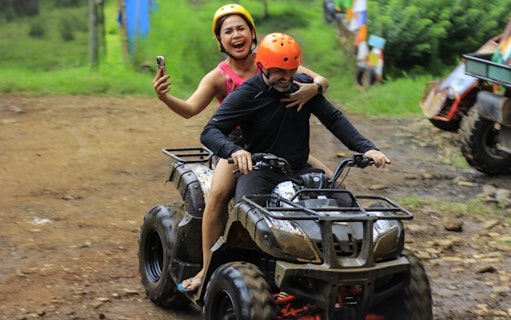 ATV ride at Dago Dreampark, Bandung, with two people enjoying the adventure.