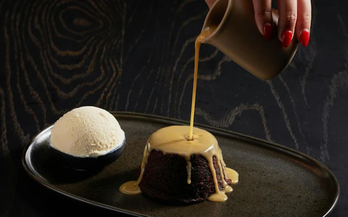 Sticky date pudding with sauce and ice cream at Cairns Aquarium dining.
